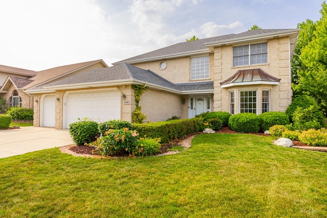 2048 Westbury Dr, Woodridge, IL 60517 - traditional-style home featuring brick siding, an attached garage, concrete driveway, and a front yard