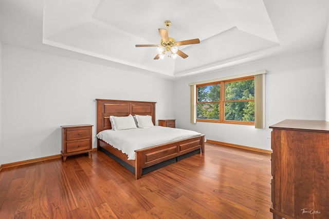 2048 Westbury Dr, Woodridge, IL 60517 - bedroom with a tray ceiling, dark wood-style flooring, and ceiling fan