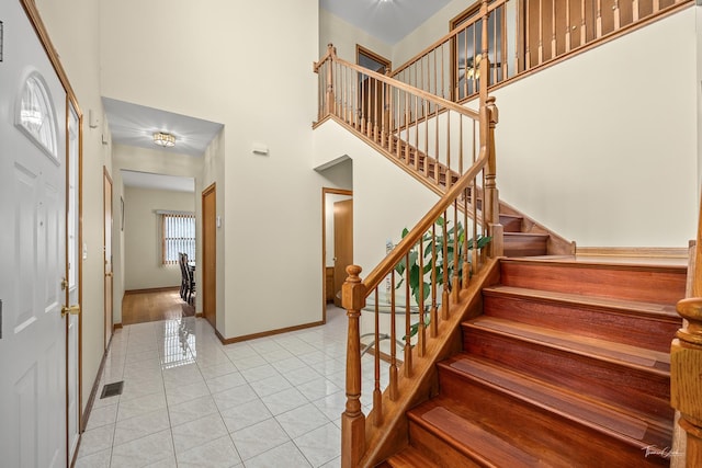 2048 Westbury Dr, Woodridge, IL 60517 - entryway featuring stairway, light tile patterned flooring, and a high ceiling