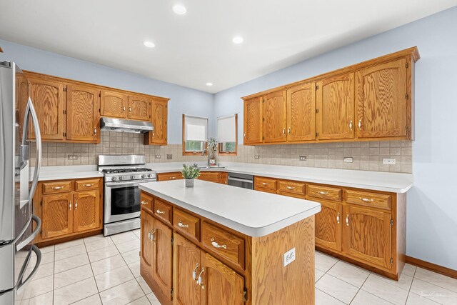 2048 Westbury Dr, Woodridge, IL 60517 - kitchen with stainless steel appliances, under cabinet range hood, light countertops, a kitchen island, and tasteful backsplash