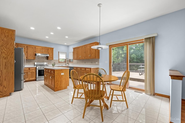 2048 Westbury Dr, Woodridge, IL 60517 - kitchen with stainless steel appliances, under cabinet range hood, backsplash, light tile patterned floors, and light countertops