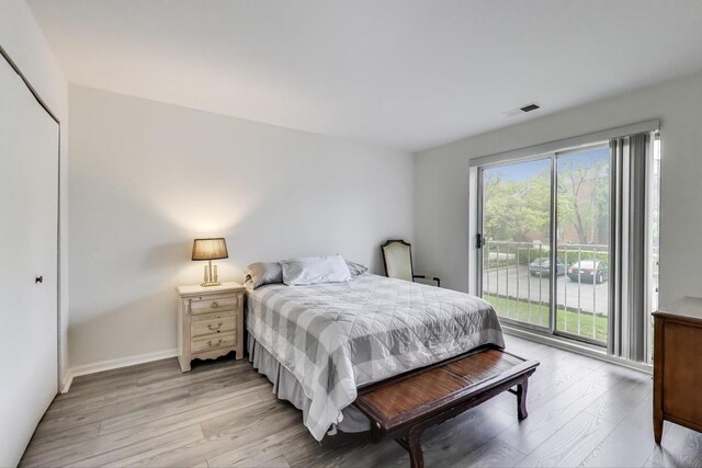 805 Leicester Rd Unit B105, Elk Grove Village, IL 60007 - bedroom with access to outside, light wood-type flooring, and baseboards
