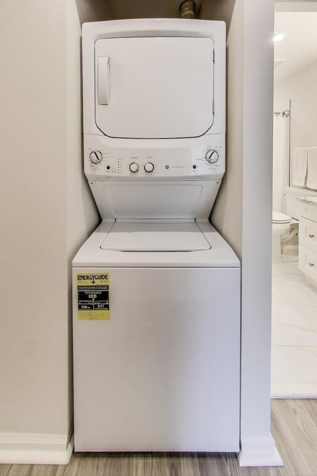 805 Leicester Rd Unit B105, Elk Grove Village, IL 60007 - laundry room with stacked washer / dryer and light wood finished floors