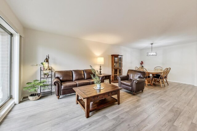805 Leicester Rd Unit B105, Elk Grove Village, IL 60007 - living area with light wood-style floors, a chandelier, and baseboards