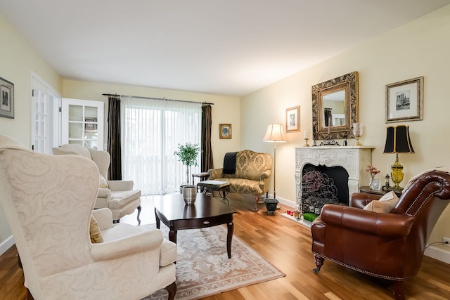 1700 Northfield Sq Unit C, Northfield, IL 60093 - living area with a fireplace, wood finished floors, and baseboards