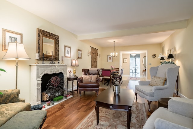 1700 Northfield Sq Unit C, Northfield, IL 60093 - living area with a chandelier, a fireplace, wood finished floors, and baseboards