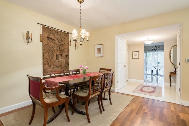 1700 Northfield Sq Unit C, Northfield, IL 60093 - dining room featuring a chandelier, wood finished floors, and baseboards