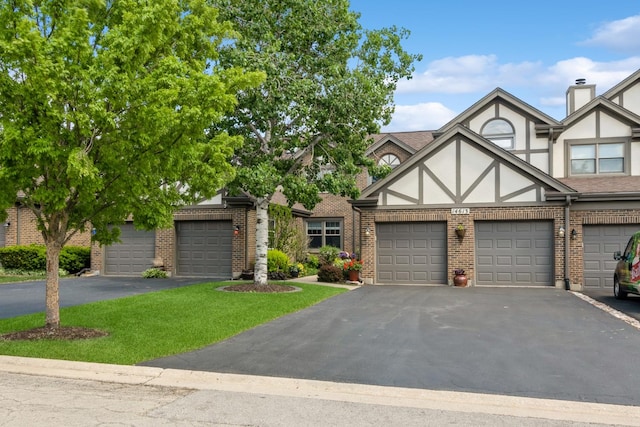 14613 Morningside Rd, Orland Park, IL 60462 - view of front of house with stucco siding, brick siding, asphalt driveway, and a front lawn