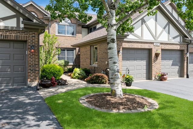 14613 Morningside Rd, Orland Park, IL 60462 - tudor house with brick siding, asphalt driveway, stucco siding, and a front yard
