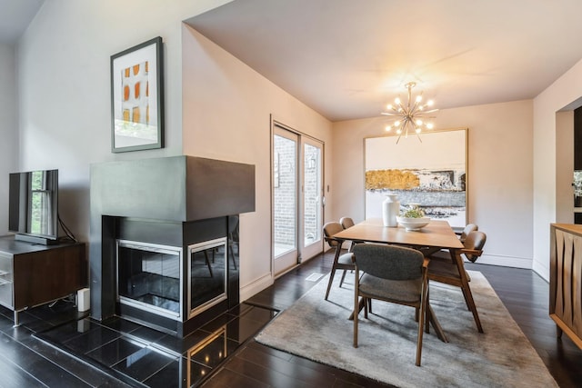 14613 Morningside Rd, Orland Park, IL 60462 - dining space featuring a chandelier, dark wood-style floors, a glass covered fireplace, and baseboards