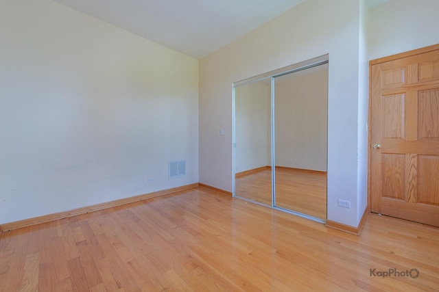 4137 S Prairie Ave Unit 3, Chicago, IL 60653 - unfurnished bedroom with light wood-style floors, a closet, and baseboards