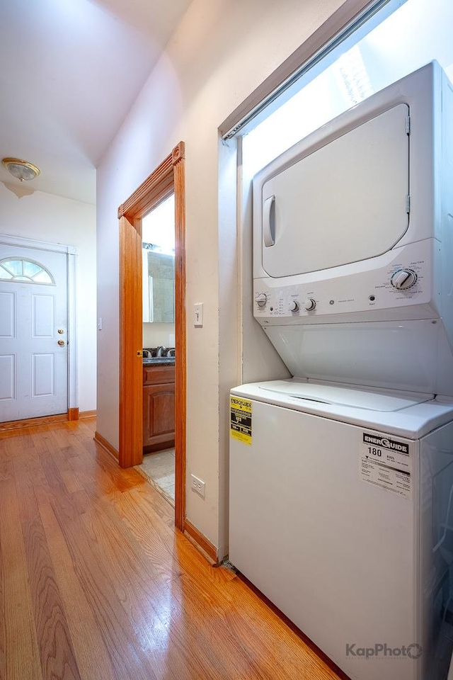 4137 S Prairie Ave Unit 3, Chicago, IL 60653 - laundry room featuring estacked washer and dryer, light wood-style flooring, and baseboards