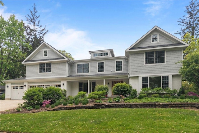 1410 Wincanton Dr, Deerfield, IL 60015 - shingle-style home with a front lawn, concrete driveway, covered porch, and brick siding