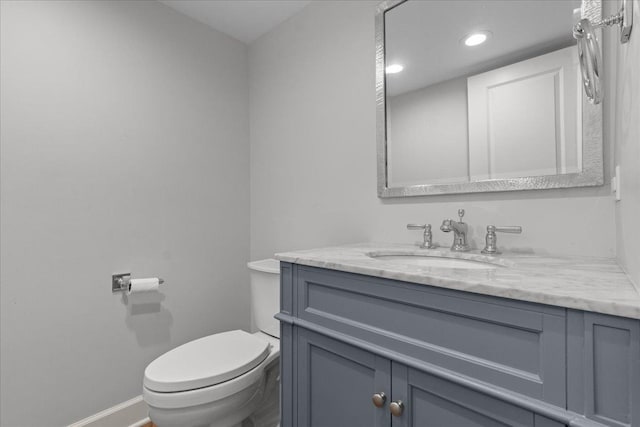1410 Wincanton Dr, Deerfield, IL 60015 - half bathroom featuring vanity, baseboards, toilet, and recessed lighting