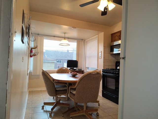 10153 S Saint Lawrence Ave, Chicago, IL 60628 - dining space with light tile patterned floors, a ceiling fan, and a desk