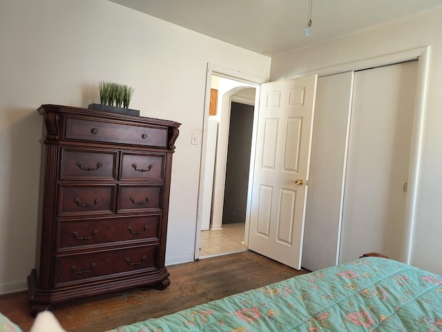 10153 S Saint Lawrence Ave, Chicago, IL 60628 - bedroom with arched walkways, wood finished floors, and a closet