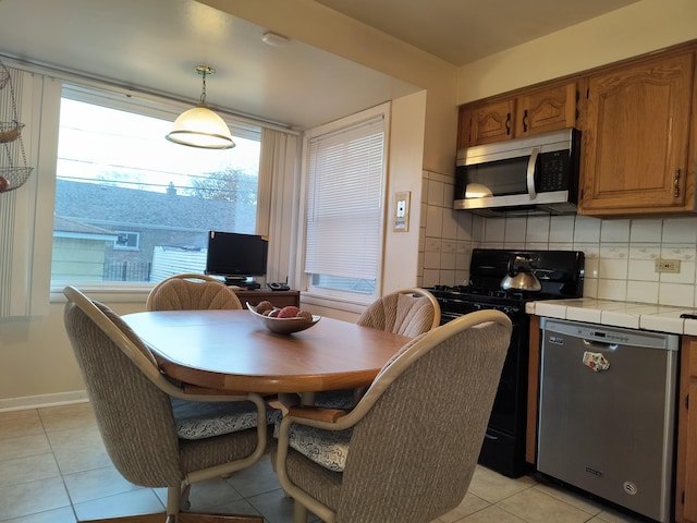 10153 S Saint Lawrence Ave, Chicago, IL 60628 - dining area featuring light tile patterned floors