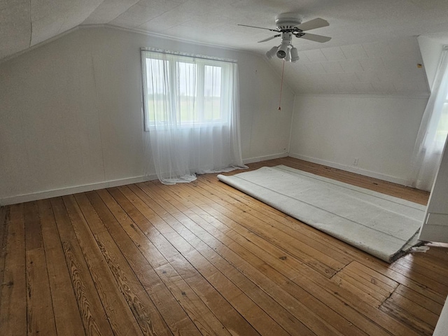 23018 Freeport Rd, Sterling, IL 61081 - additional living space with a ceiling fan, hardwood / wood-style floors, vaulted ceiling, and baseboards