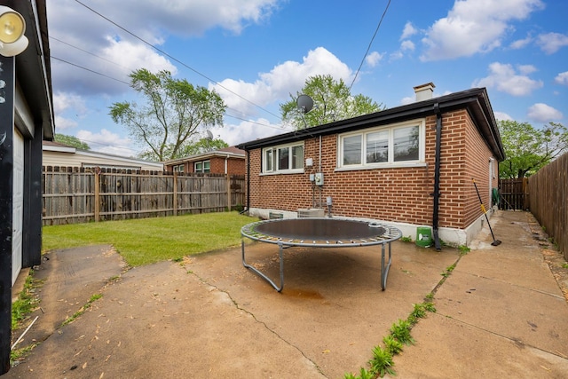 2816 E 127th St, Chicago, IL 60633 - back of house with brick siding, a trampoline, a chimney, and a patio