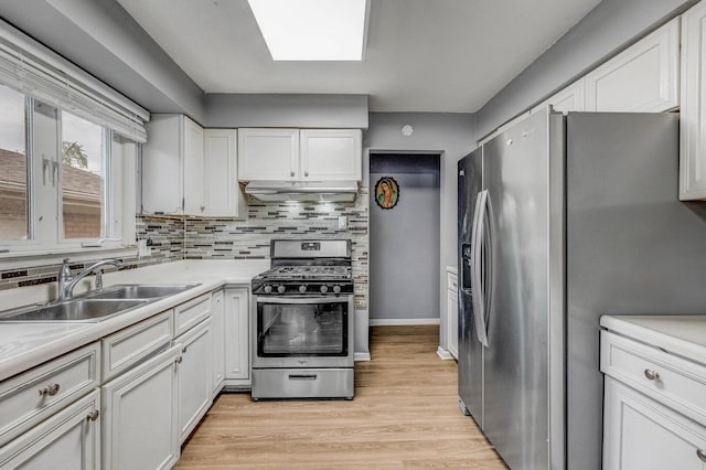 2816 E 127th St, Chicago, IL 60633 - kitchen with stainless steel appliances, a sink, under cabinet range hood, and white cabinetry