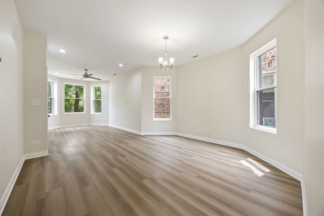 5622 S Laflin St, Chicago, IL 60636 - empty room with recessed lighting, wood finished floors, a chandelier, baseboards, and a ceiling fan