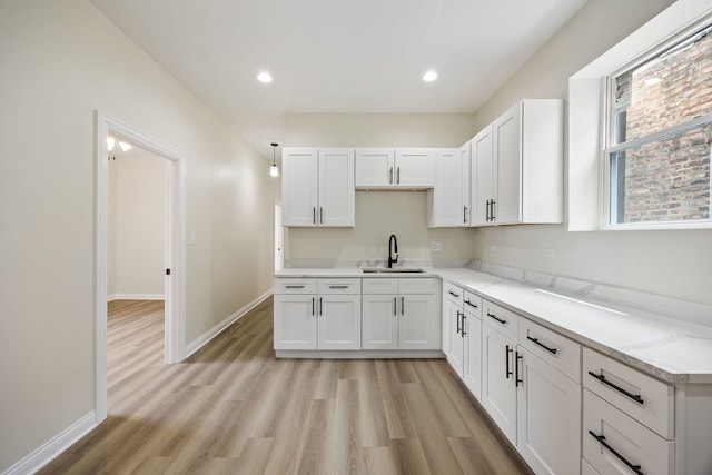 5622 S Laflin St, Chicago, IL 60636 - kitchen featuring a sink, light wood-style flooring, white cabinetry, baseboards, and recessed lighting