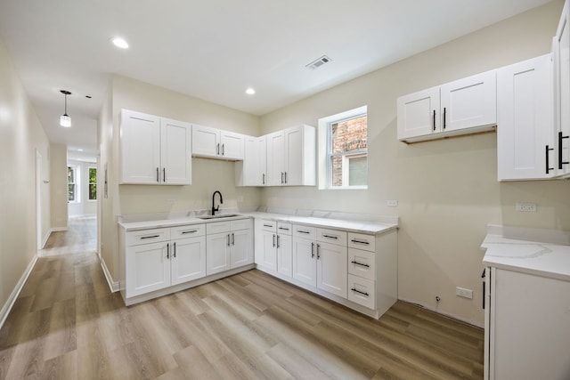 5622 S Laflin St, Chicago, IL 60636 - kitchen featuring a sink, white cabinetry, light wood-style floors, recessed lighting, and baseboards