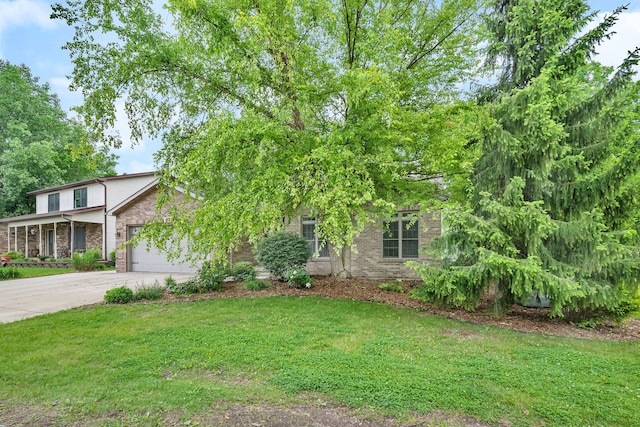 480 Logue Cir, Seneca, IL 61360 - view of property hidden behind natural elements with brick siding, driveway, an attached garage, and a front lawn