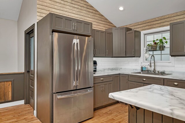 480 Logue Cir, Seneca, IL 61360 - kitchen featuring freestanding refrigerator, a sink, vaulted ceiling, light wood-style flooring, and light stone counters