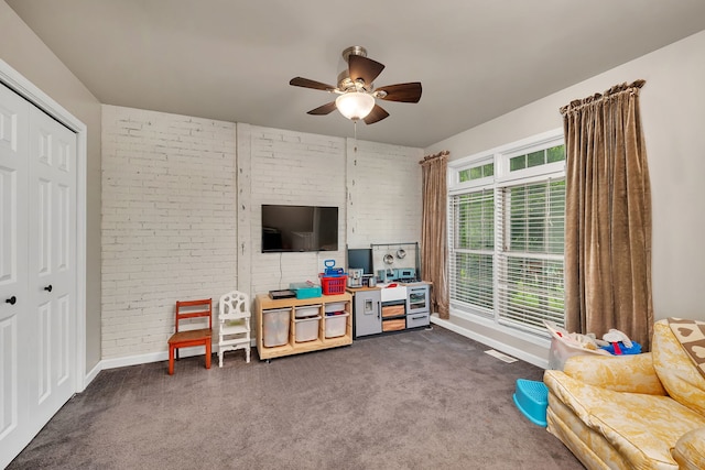 480 Logue Cir, Seneca, IL 61360 - living room featuring brick wall, ceiling fan, dark colored carpet, and baseboards