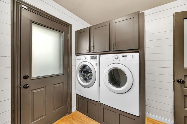 480 Logue Cir, Seneca, IL 61360 - washroom with washing machine and clothes dryer, cabinet space, and light wood-style floors