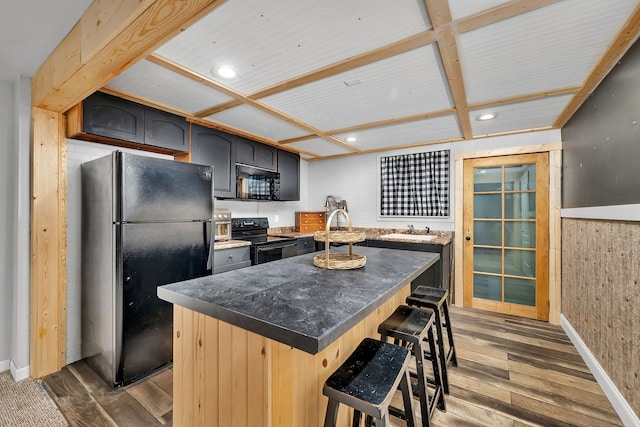 480 Logue Cir, Seneca, IL 61360 - kitchen featuring black appliances, a sink, dark wood-type flooring, a kitchen breakfast bar, and a center island