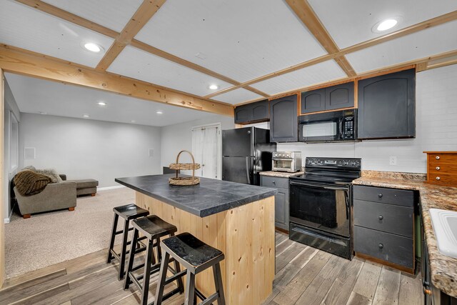 480 Logue Cir, Seneca, IL 61360 - kitchen featuring black appliances, a kitchen breakfast bar, light wood finished floors, a center island, and recessed lighting