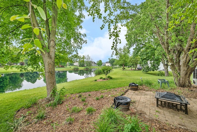 480 Logue Cir, Seneca, IL 61360 - view of grassy yard with a fire pit, a water view, and a patio
