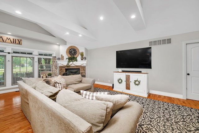 480 Logue Cir, Seneca, IL 61360 - living room featuring baseboards, vaulted ceiling, a glass covered fireplace, recessed lighting, and light wood-style floors