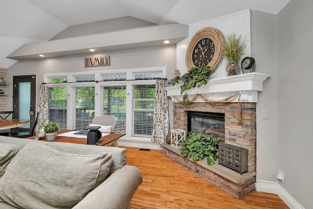 480 Logue Cir, Seneca, IL 61360 - living area featuring wood finished floors, lofted ceiling, a stone fireplace, recessed lighting, and baseboards