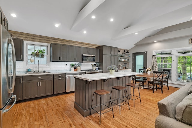 480 Logue Cir, Seneca, IL 61360 - kitchen featuring appliances with stainless steel finishes, vaulted ceiling, a sink, a breakfast bar area, and recessed lighting