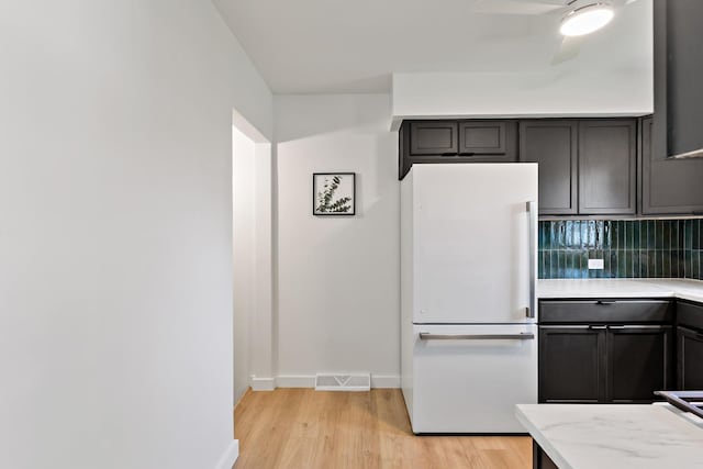3634 177th St, Lansing, IL 60438 - kitchen with freestanding refrigerator, light wood-style flooring, backsplash, baseboards, and ceiling fan