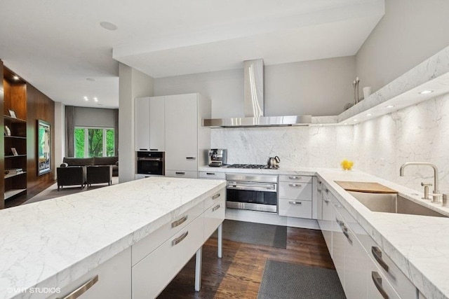 1733 S Prairie Ave, Chicago, IL 60616 - kitchen featuring oven, wall chimney exhaust hood, a sink, dark wood-style flooring, and recessed lighting