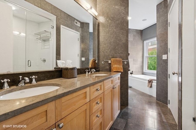 1733 S Prairie Ave, Chicago, IL 60616 - bathroom featuring tile walls, a garden tub, tile patterned flooring, double vanity, and a stall shower