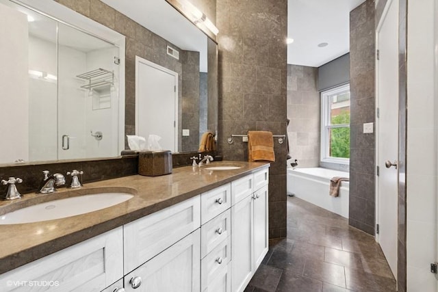 1733 S Prairie Ave, Chicago, IL 60616 - full bathroom with tile walls, double vanity, a garden tub, tile patterned flooring, and a stall shower