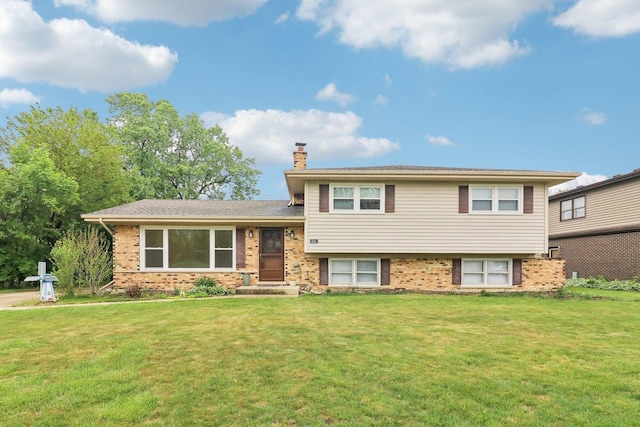 409 Wingate Dr, Schaumburg, IL 60193 - split level home featuring a chimney, brick siding, and a front lawn