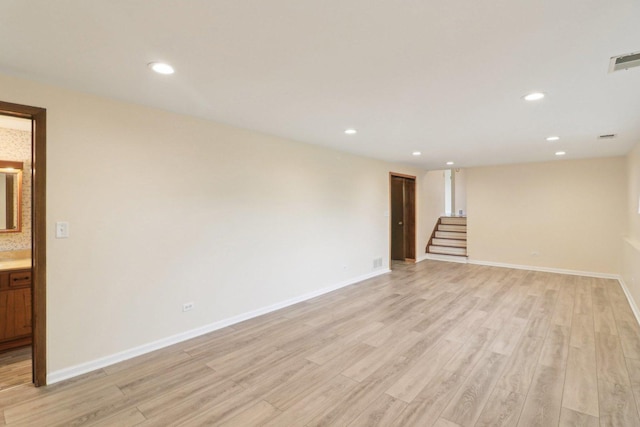 409 Wingate Dr, Schaumburg, IL 60193 - unfurnished room featuring light wood-style floors, stairs, recessed lighting, and baseboards