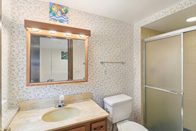 409 Wingate Dr, Schaumburg, IL 60193 - bathroom with vanity, wallpapered walls, a shower stall, and toilet