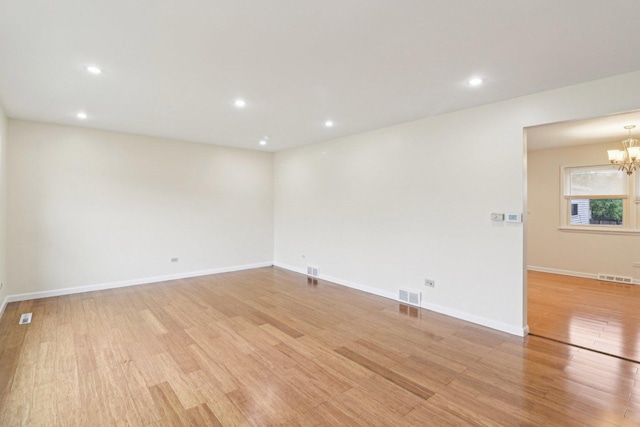 409 Wingate Dr, Schaumburg, IL 60193 - empty room featuring light wood-style floors, a chandelier, recessed lighting, and baseboards