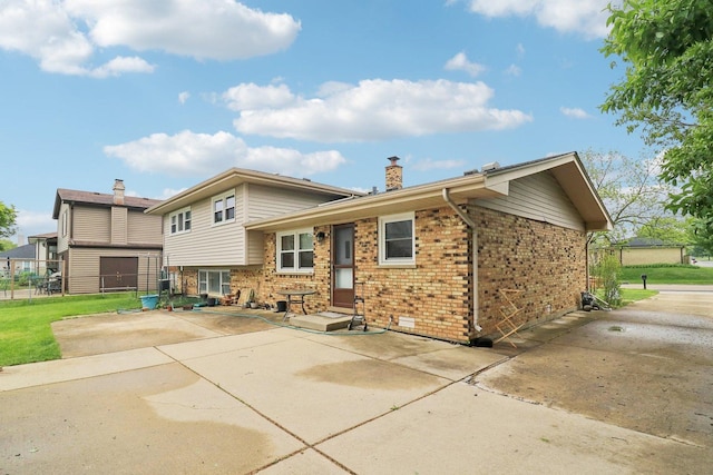 409 Wingate Dr, Schaumburg, IL 60193 - back of property with a chimney, brick siding, and a patio