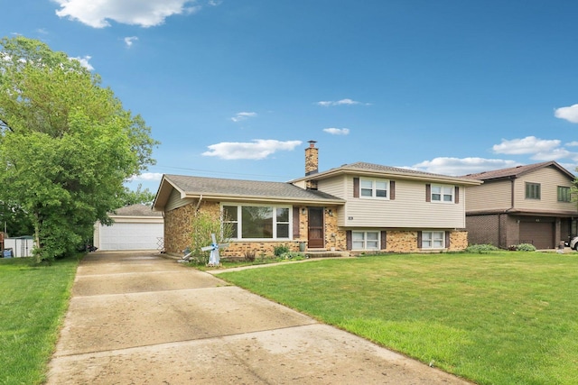 409 Wingate Dr, Schaumburg, IL 60193 - tri-level home with a chimney, a front yard, brick siding, and a garage
