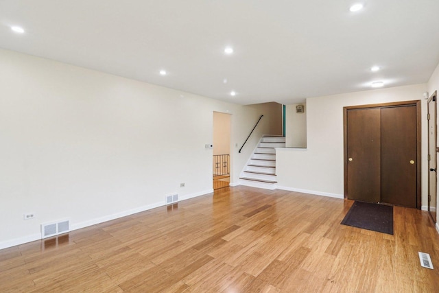 409 Wingate Dr, Schaumburg, IL 60193 - unfurnished living room with stairway, light wood finished floors, recessed lighting, and baseboards