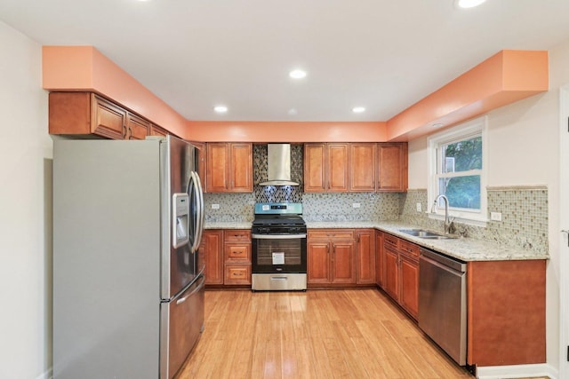 409 Wingate Dr, Schaumburg, IL 60193 - kitchen with appliances with stainless steel finishes, wall chimney range hood, a sink, brown cabinetry, and light wood-type flooring