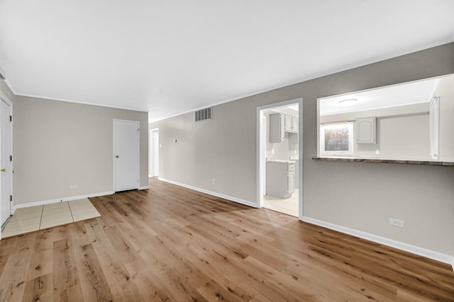 172 Nanti St, Park Forest, IL 60466 - unfurnished living room featuring light wood-type flooring, baseboards, and ornamental molding
